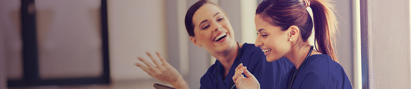 Two nurse discussing salary packaging happily