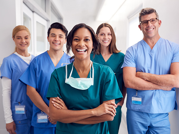 A group of happy doctors in scrubs