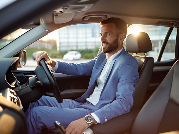 A corporate guy sitting in his car